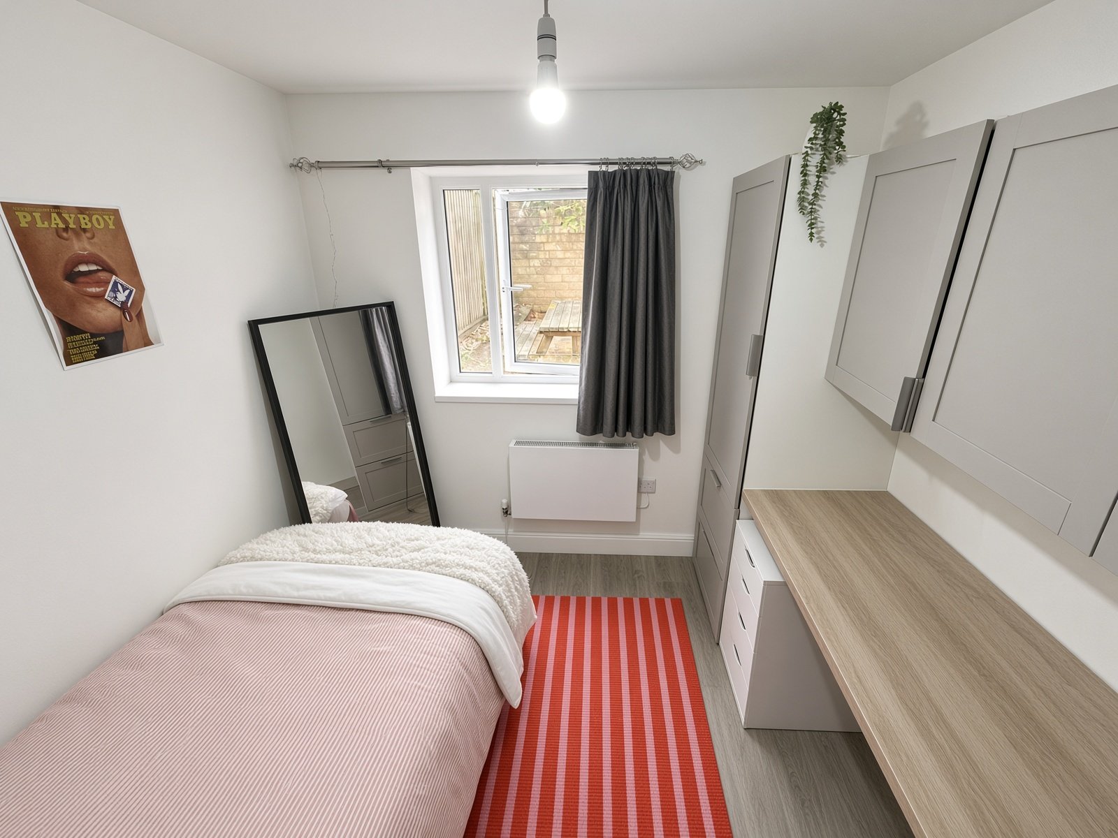 Bedroom with single bed, wardrobe and window