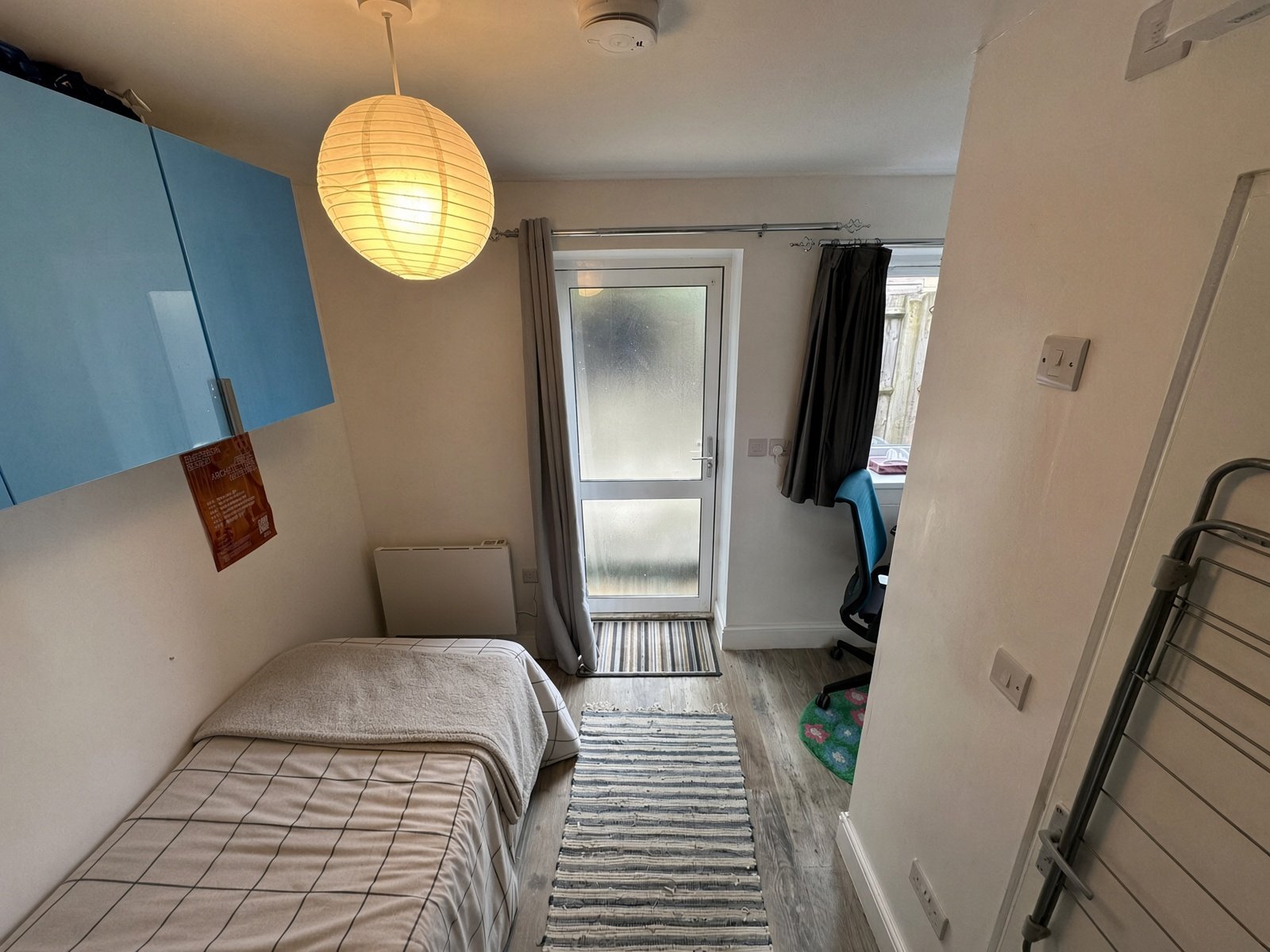 Bedroom with pendant light and glazed garden door