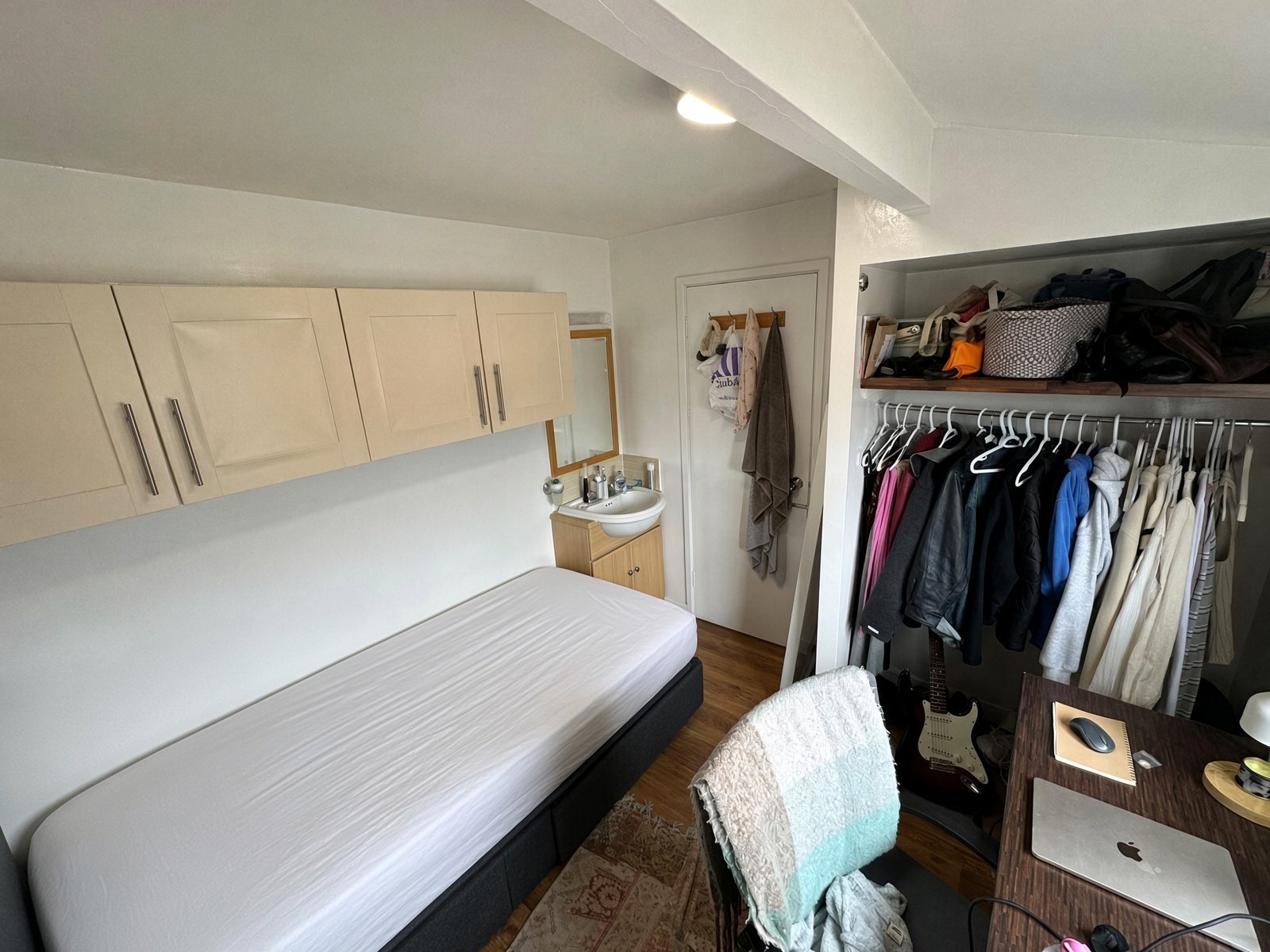 Bedroom with overhead cupboards and open wardrobe