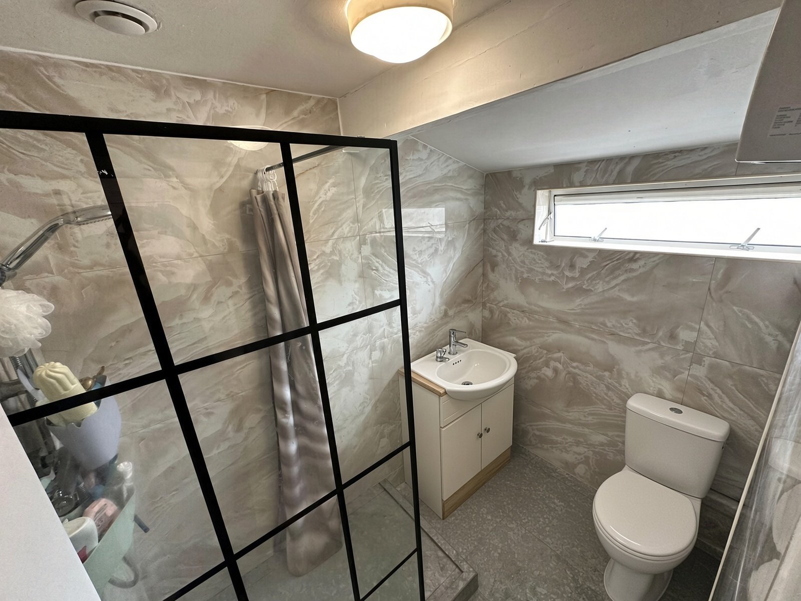Shower room with black-framed glass screen, basin and WC
