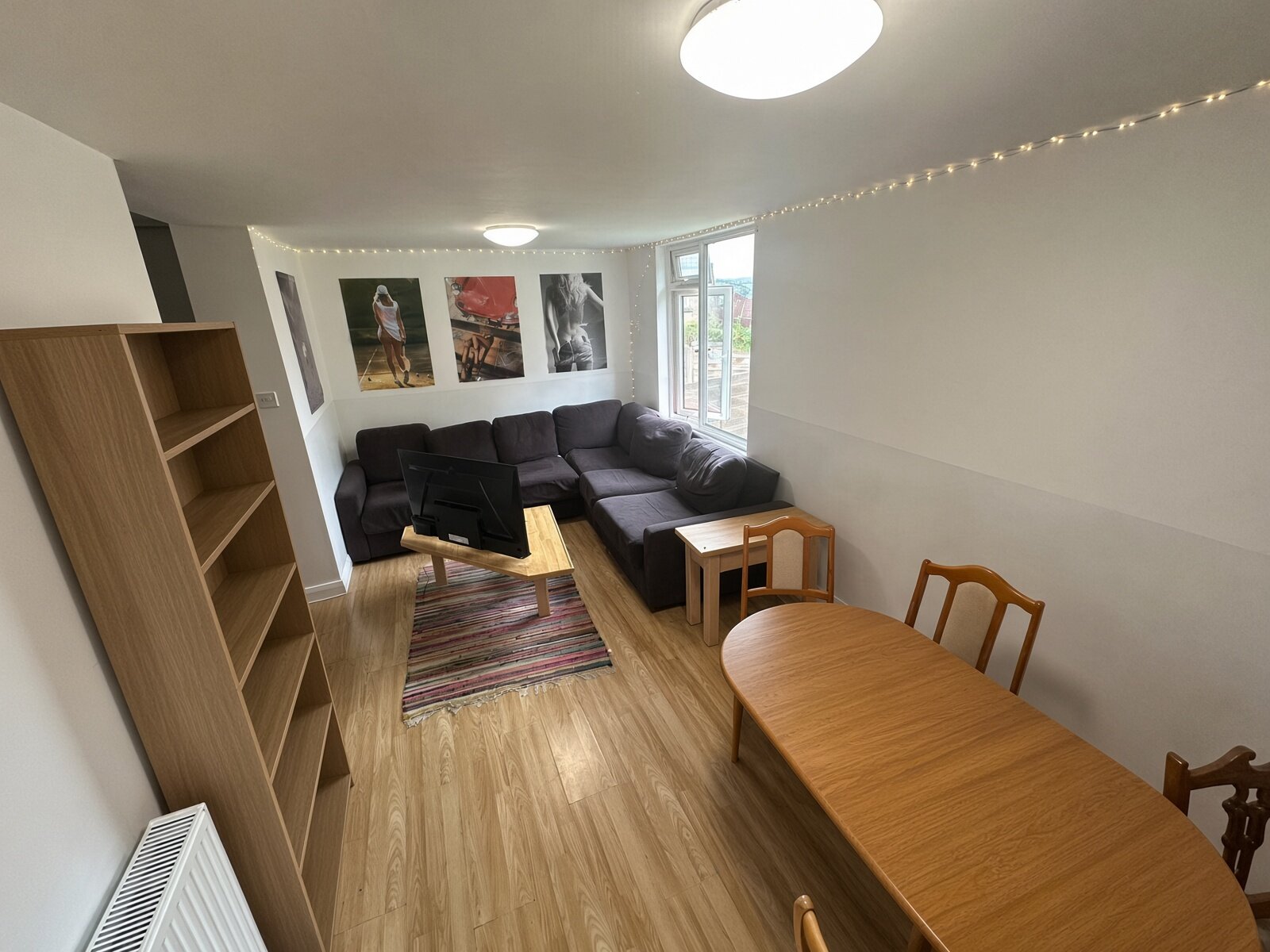 Living room with sofas, shelving and dining table