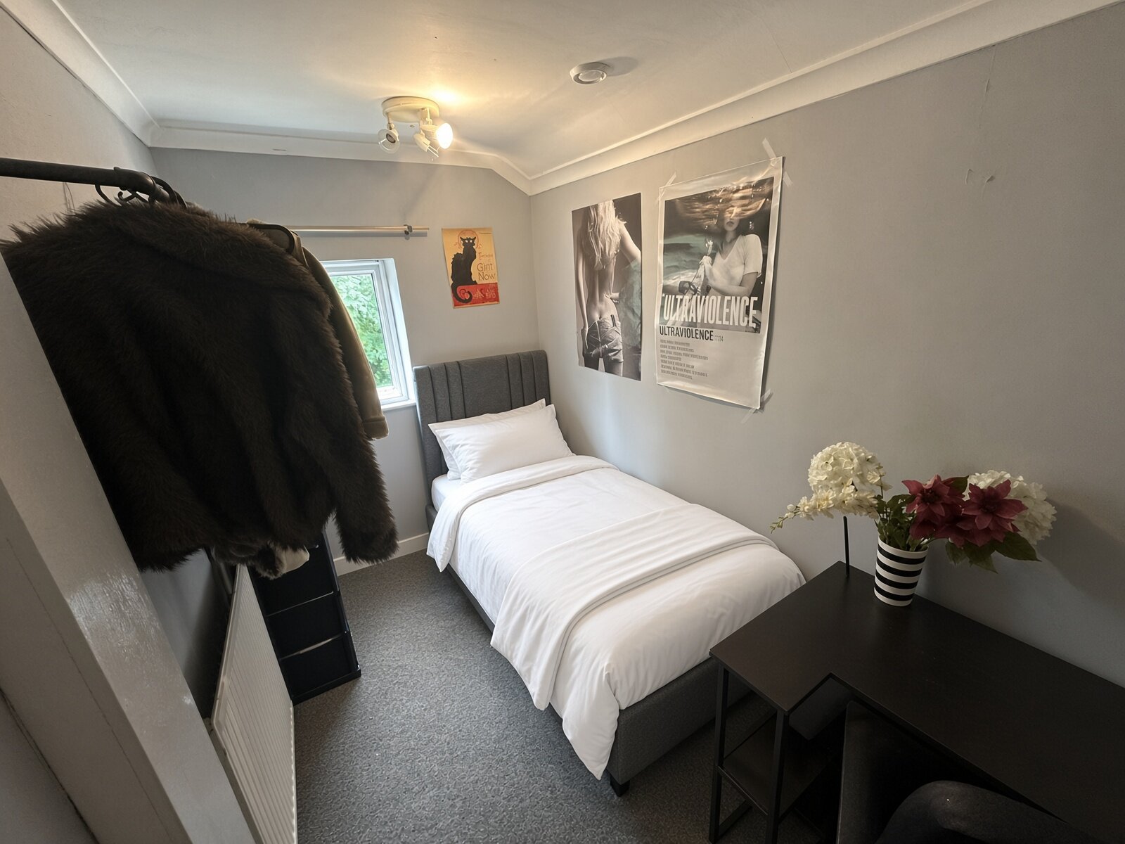Bedroom with double bed, clothes rail and desk