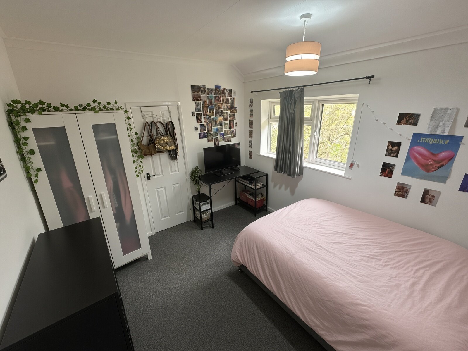Bedroom with double bed, wardrobe and desk by the window