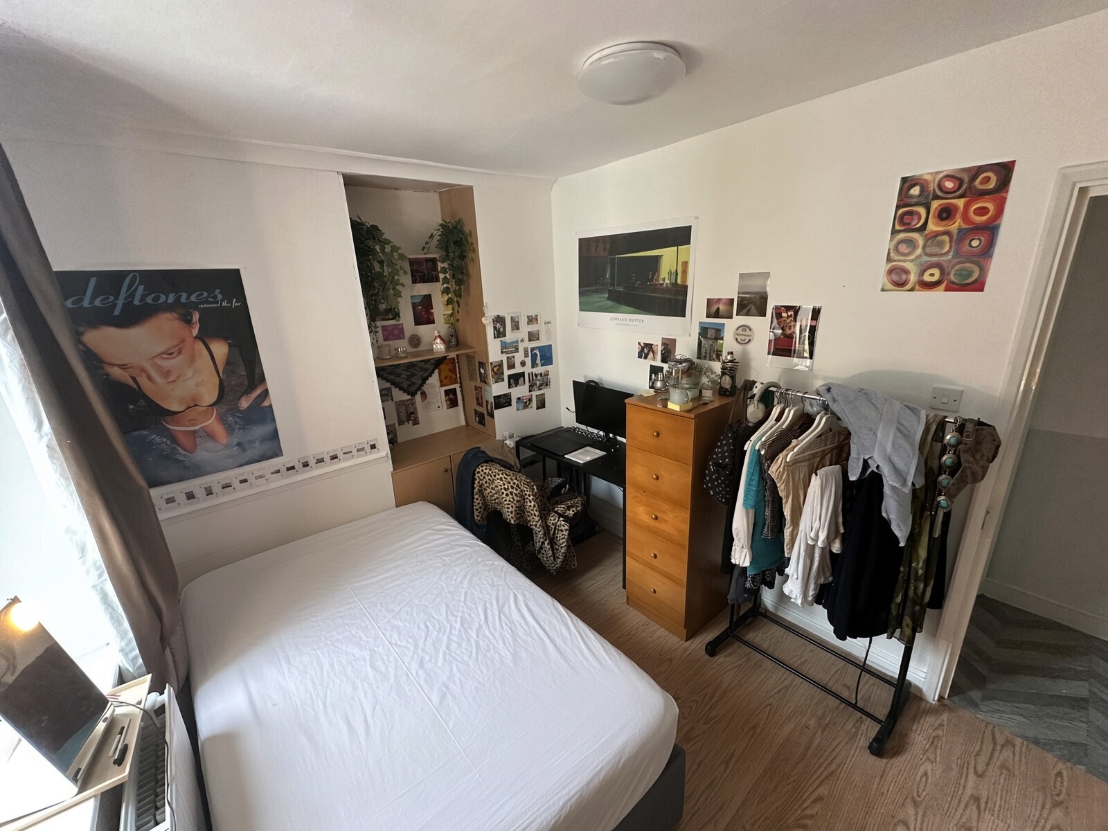 Bedroom with double bed, wardrobe and wood floor