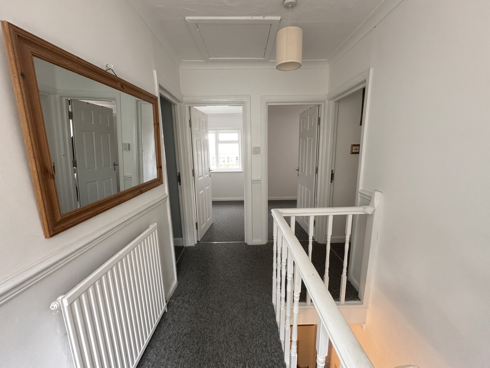 Landing with mirror and staircase