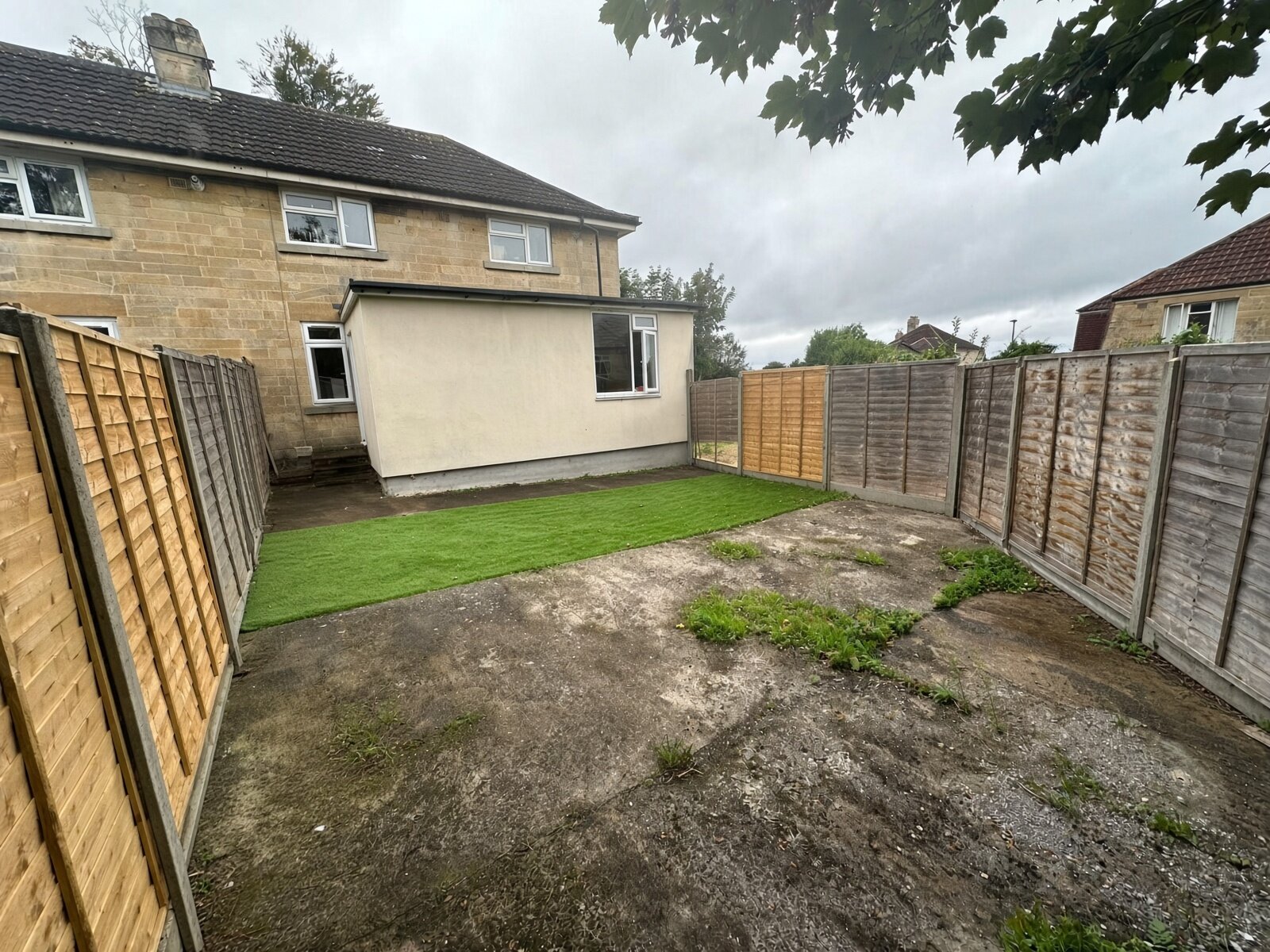 Rear garden with lawn, fencing and patio