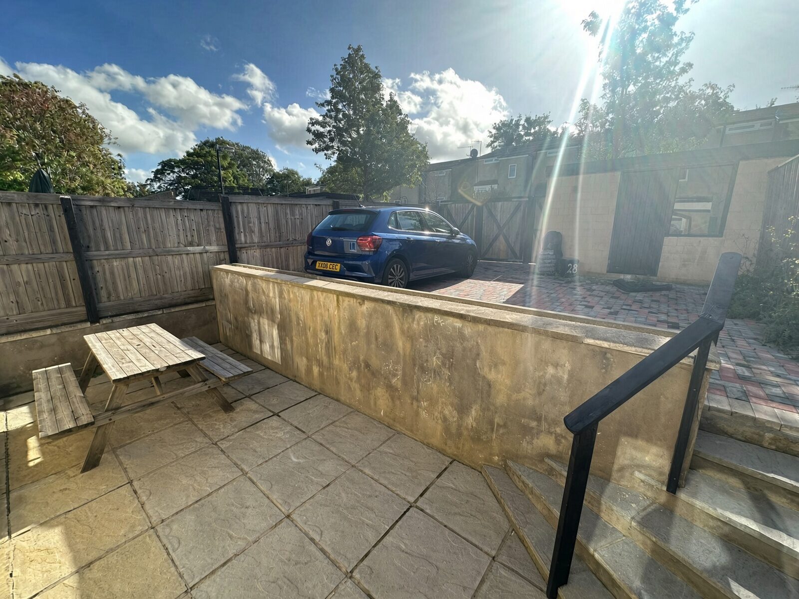 Paved garden with patio table and bench