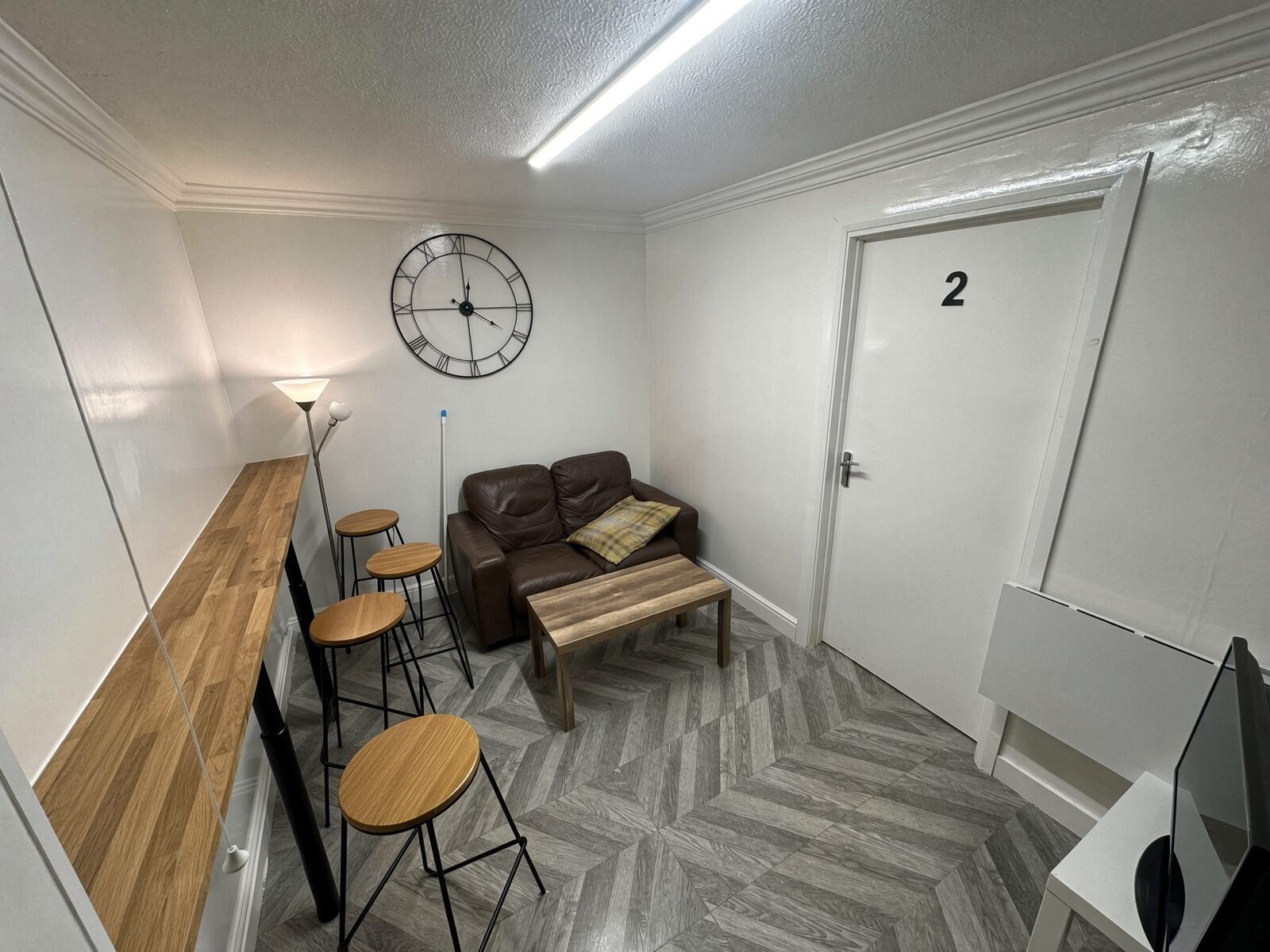 Dining area with sofa, coffee table and herringbone floor