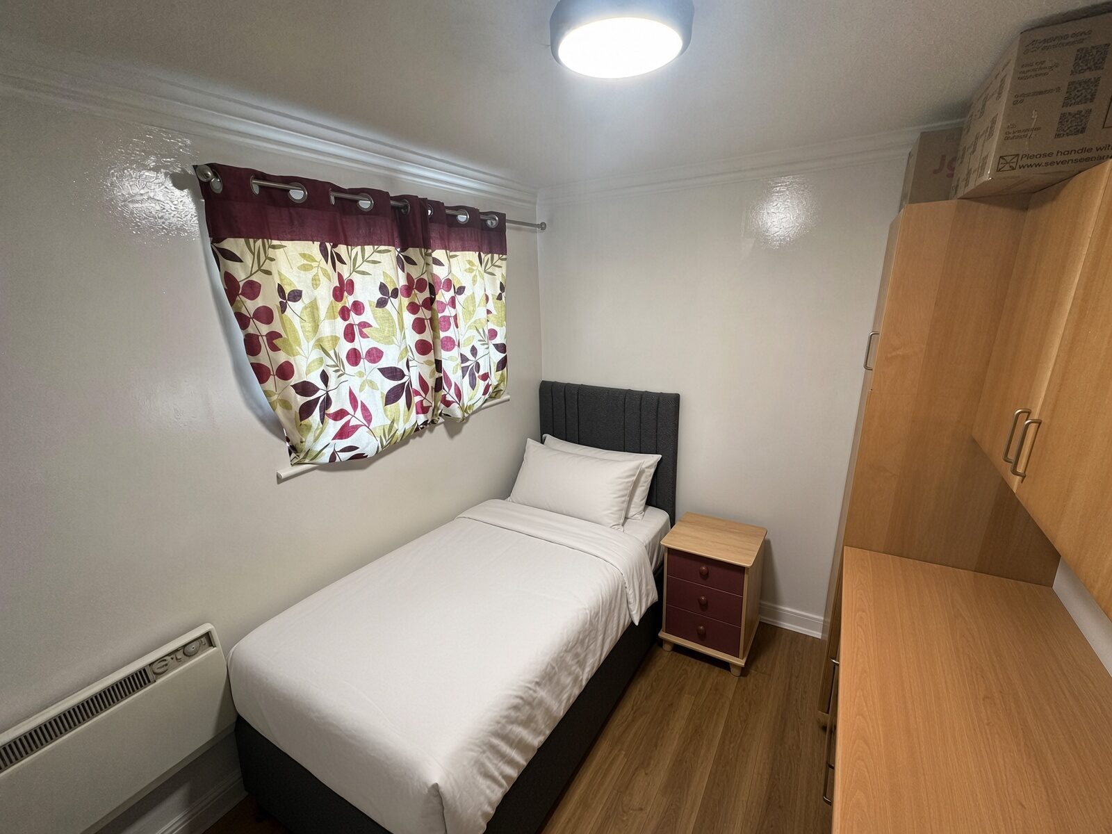 Bedroom with single bed, bedside table and window