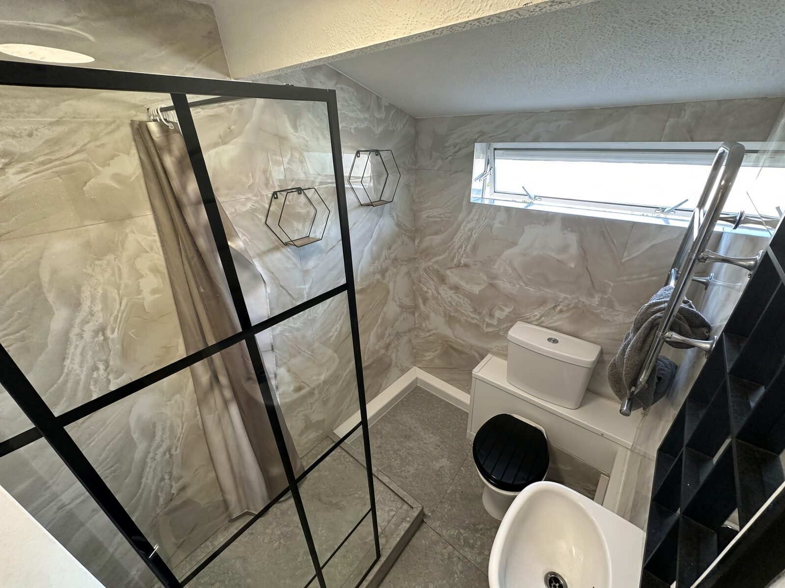 Shower room with black-framed shower screen, basin and WC