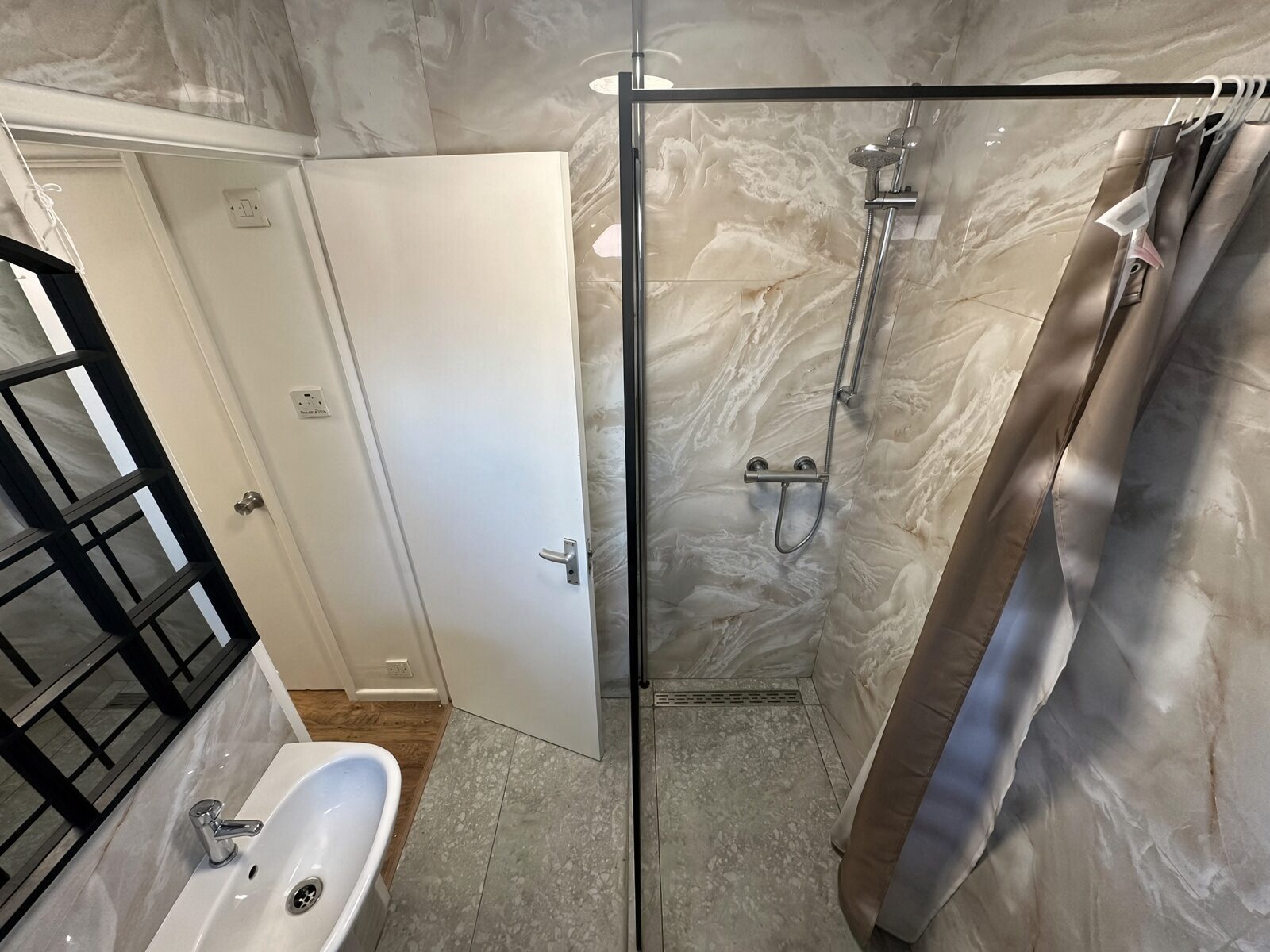 Shower room with shower enclosure and heated towel rail