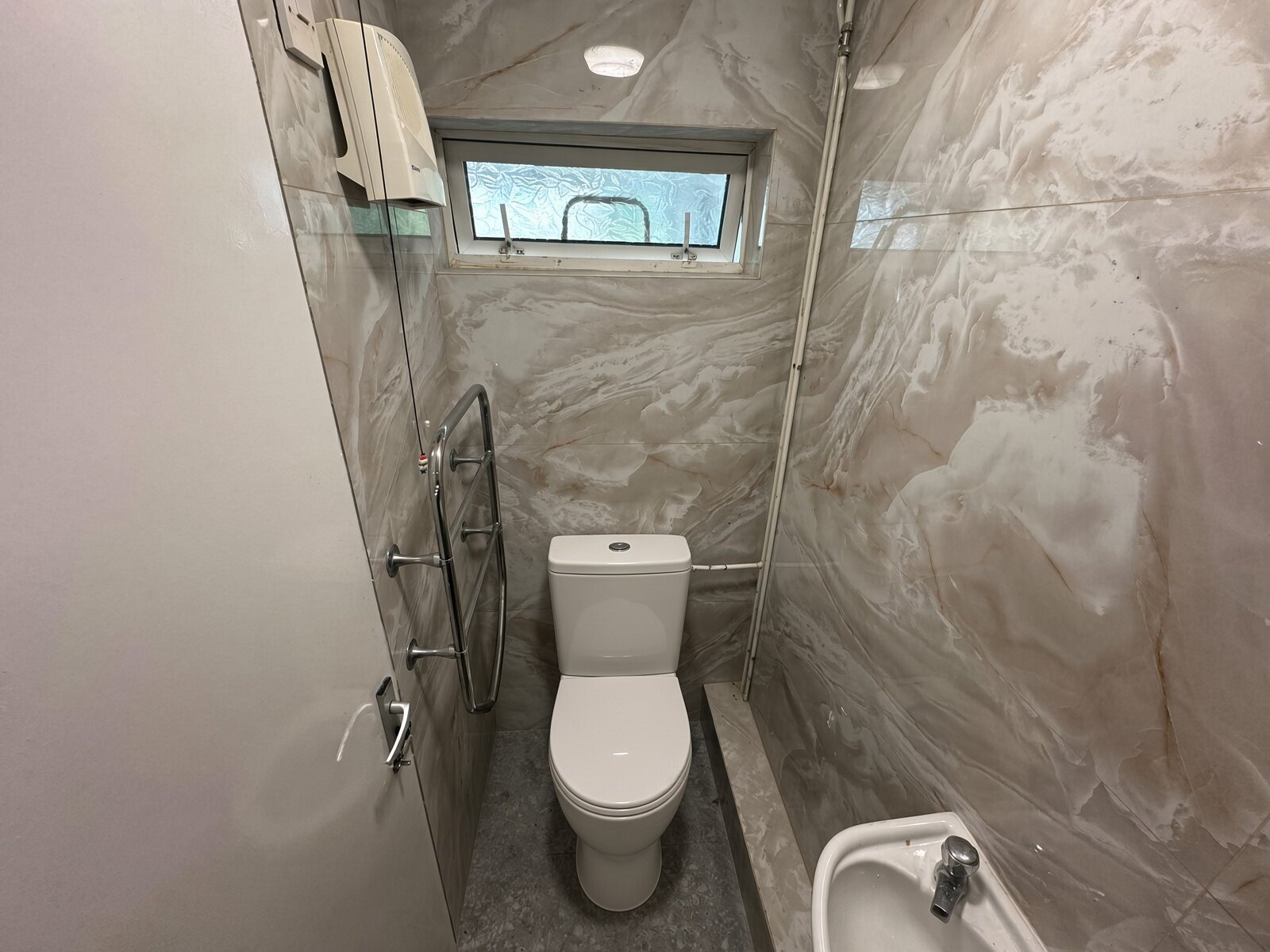 Shower room with WC, basin and heated towel rail