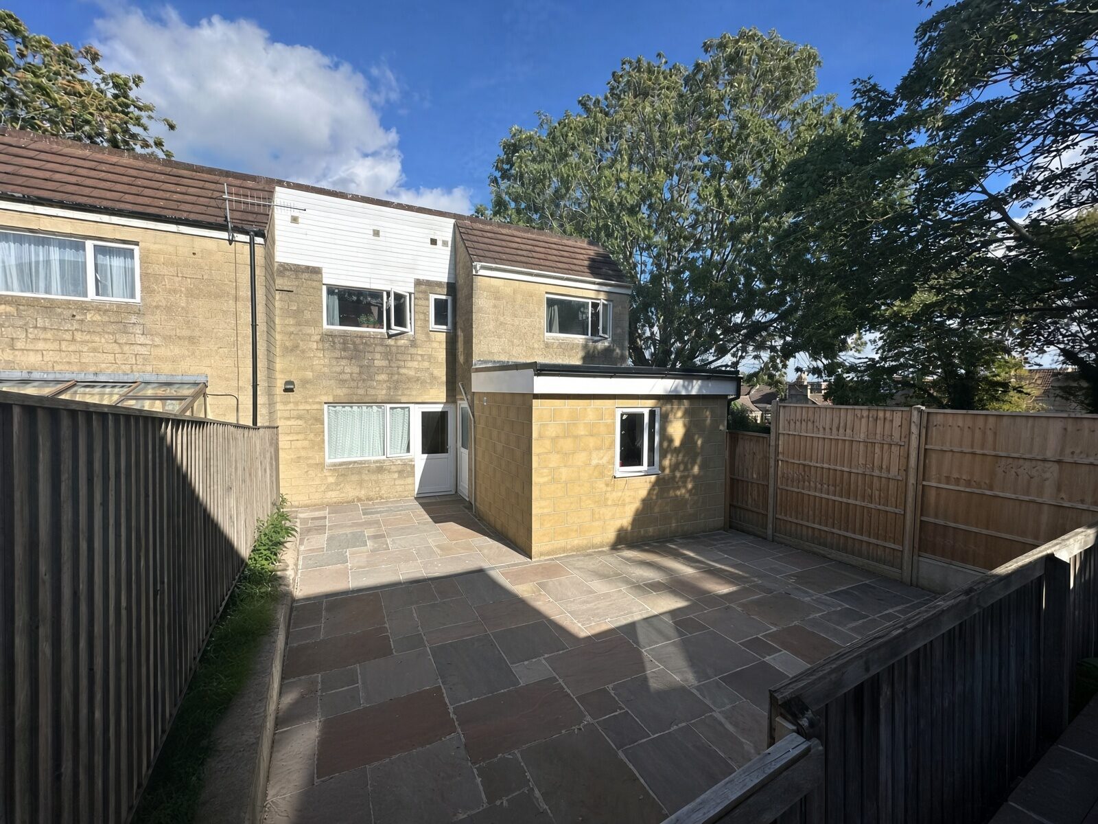 Rear garden with paved patio and fenced boundary