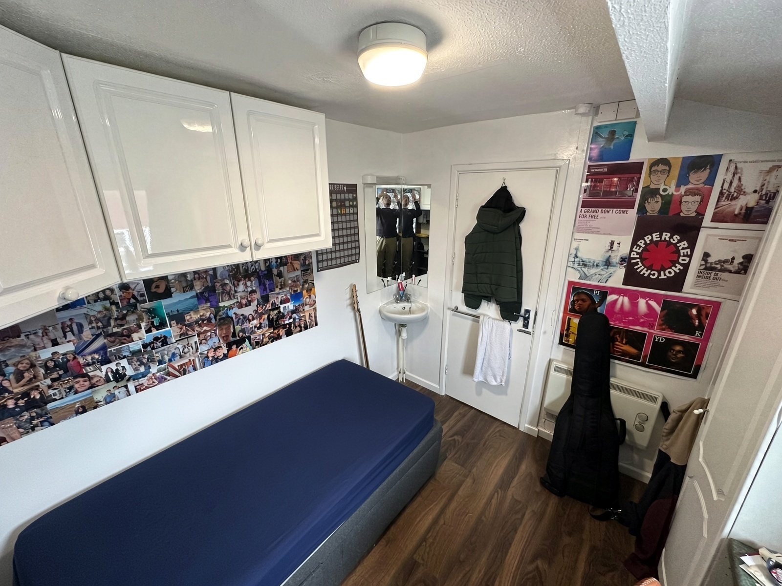 Bedroom with double bed, overhead cupboards and wardrobe