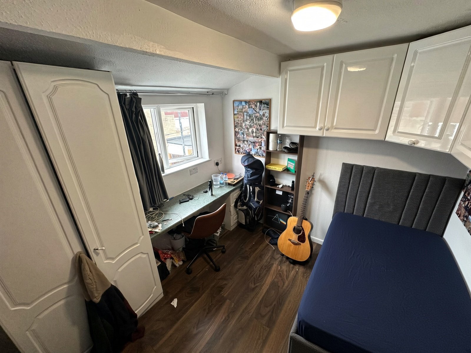 Bedroom with double bed, wardrobe and desk under the window