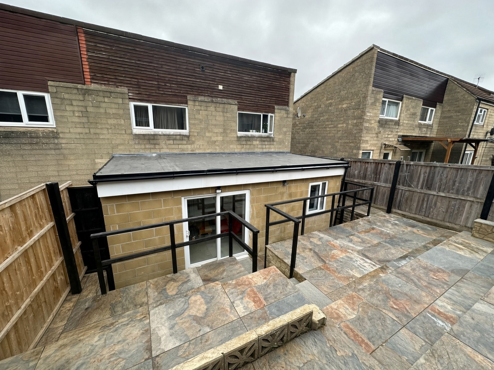 Rear of the house with tiled patio and fenced garden