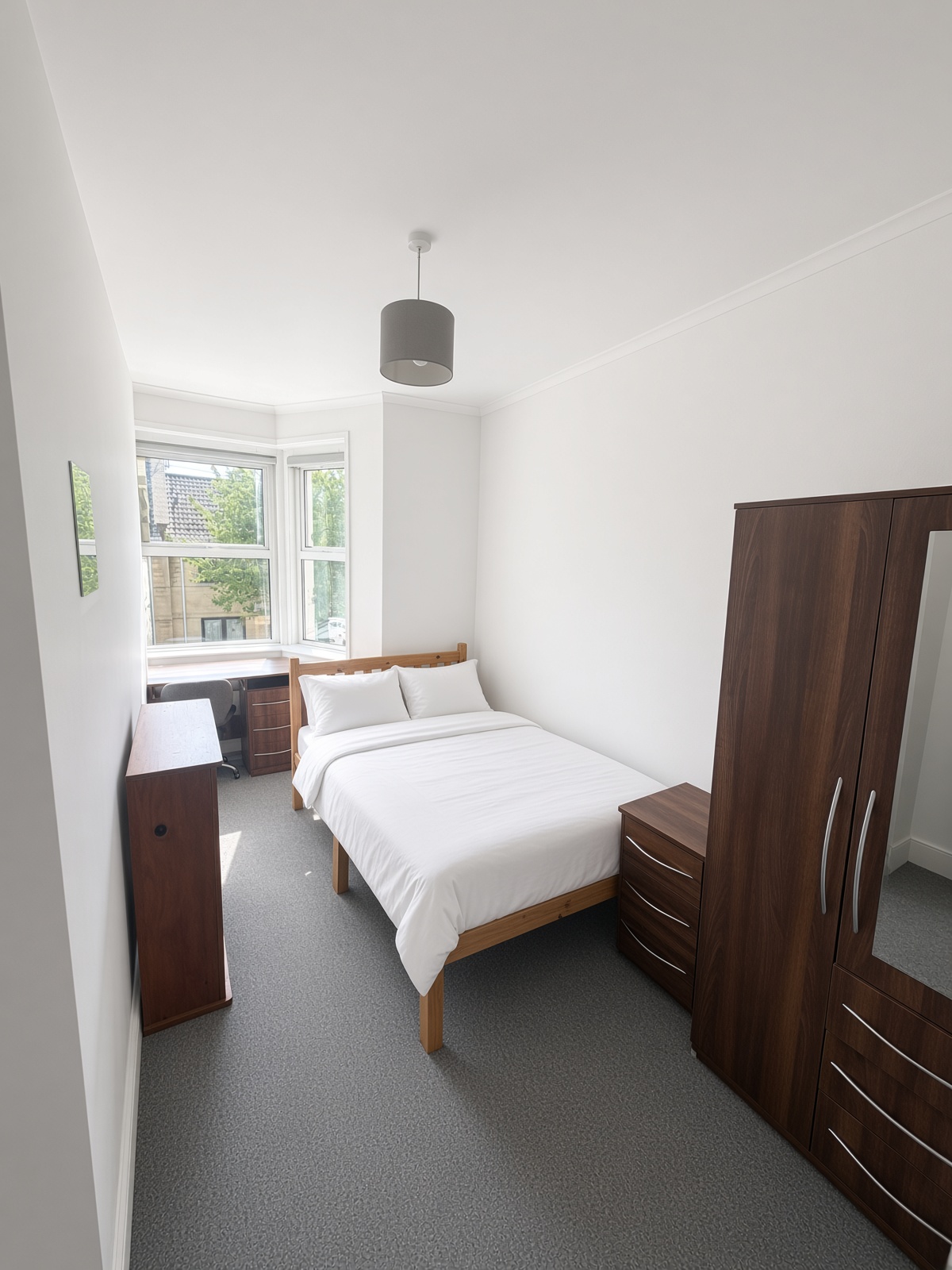 Bedroom with a bay window and a desk in the bay