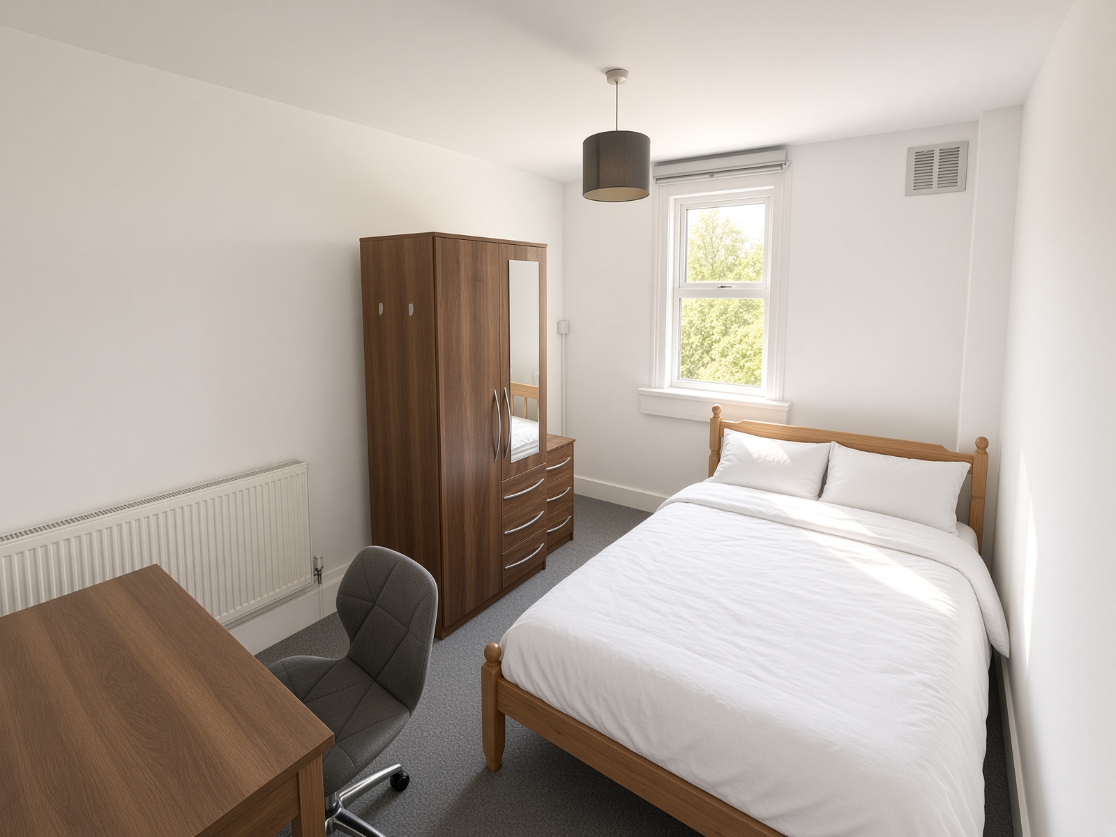 Bedroom with a wooden bed, mirrored wardrobe, and desk