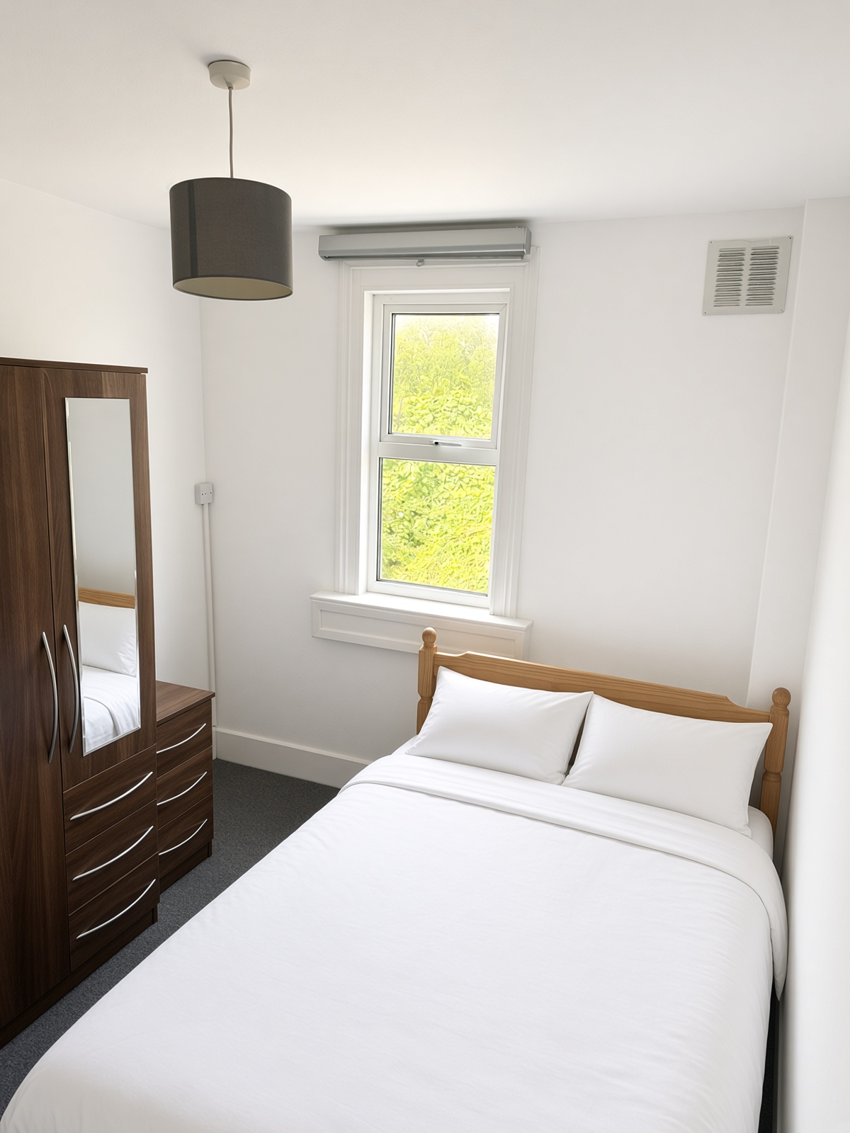 Same bedroom from another angle, looking toward the window