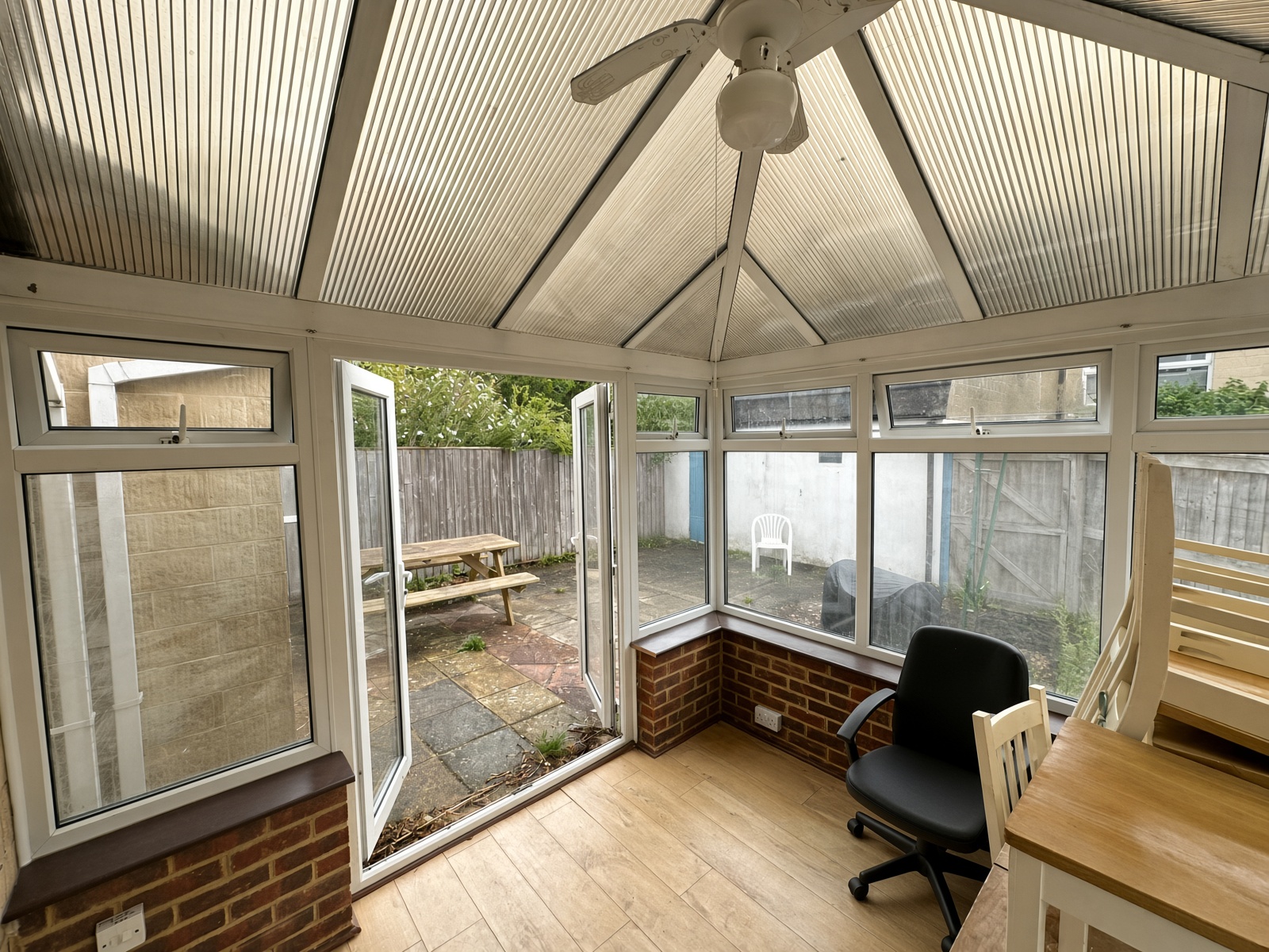 Conservatory looking out through open doors to the patio