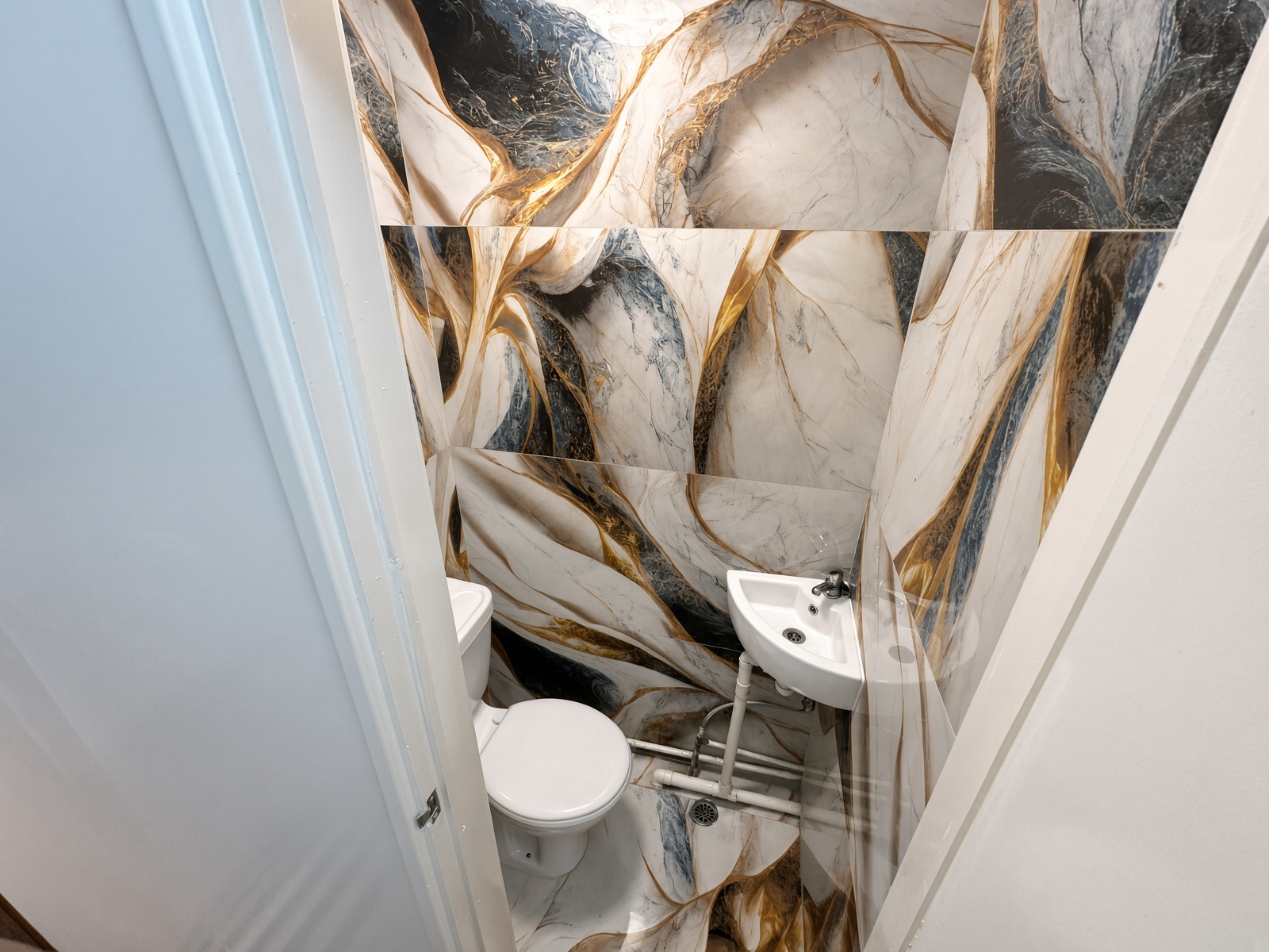 Cloakroom with marble-effect tiles, a toilet, and a corner sink