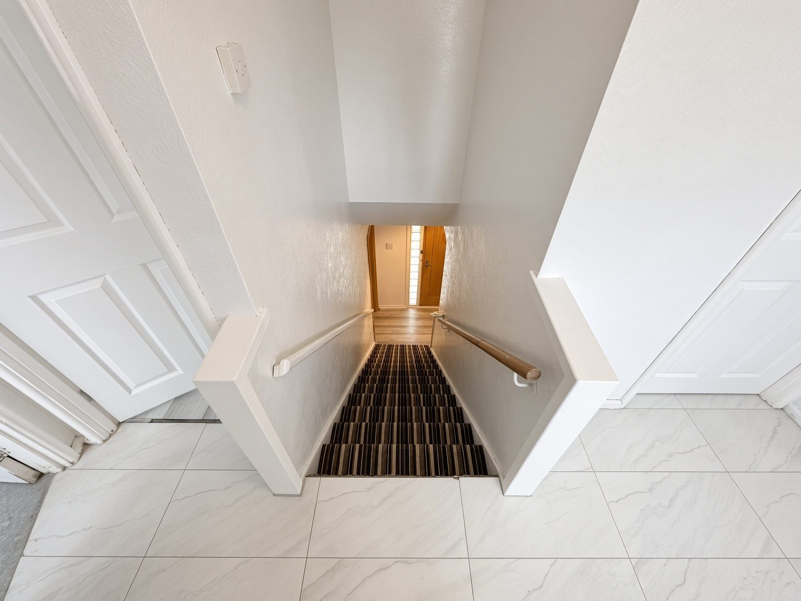 Staircase looking down from the tiled landing
