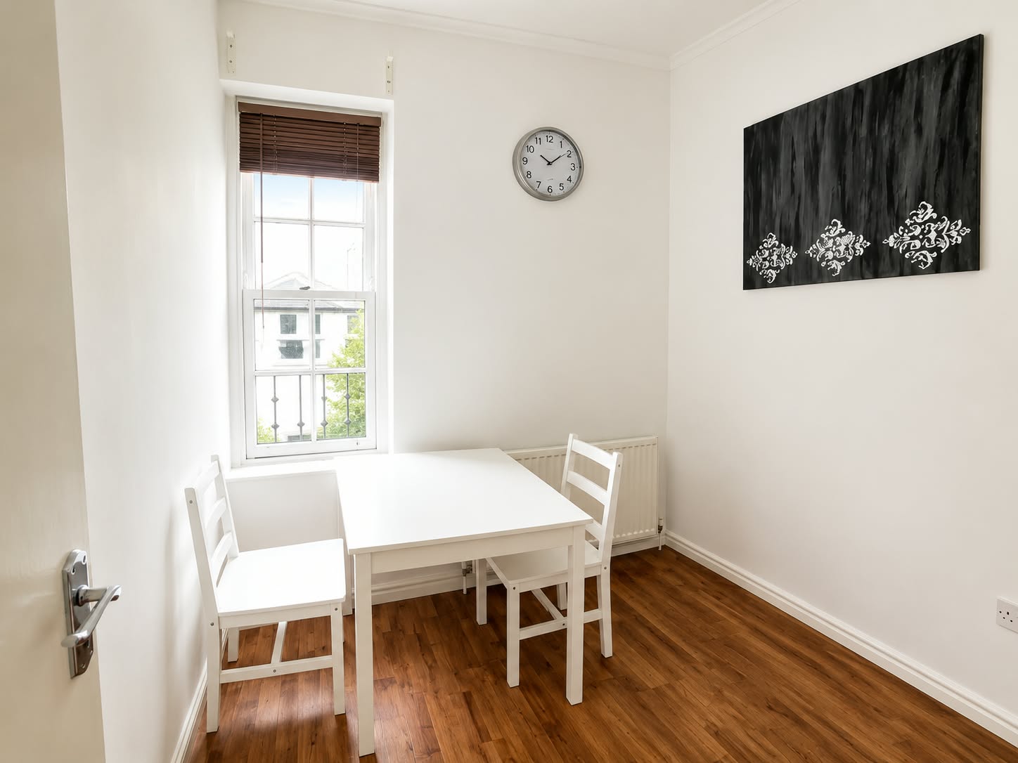Sitting and dining area with a white table and chairs